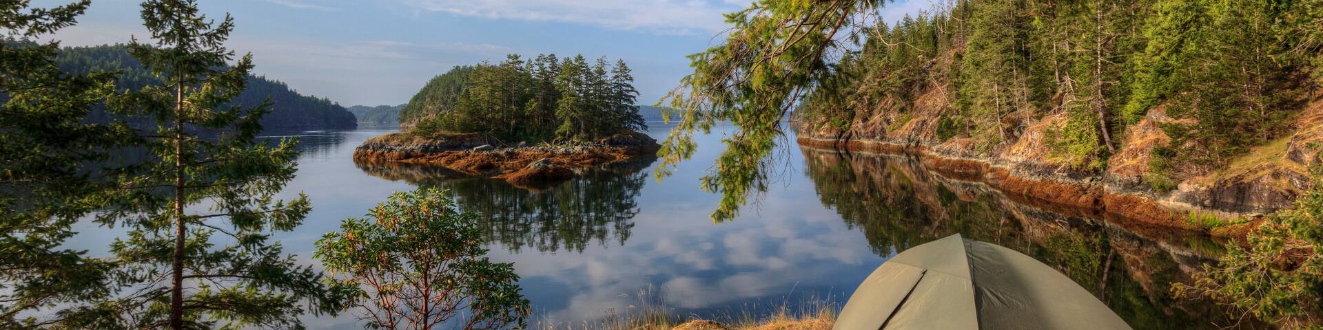 Kayakers camp on Penn Island in Sutil Channel between Read and Cortes Islands British Columbia Canada.