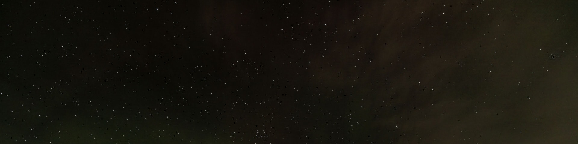 Orange, yellow and green Northern lights (aurora borealis)
above Ounasjärvi lake in Hetta, Lapland, Finland