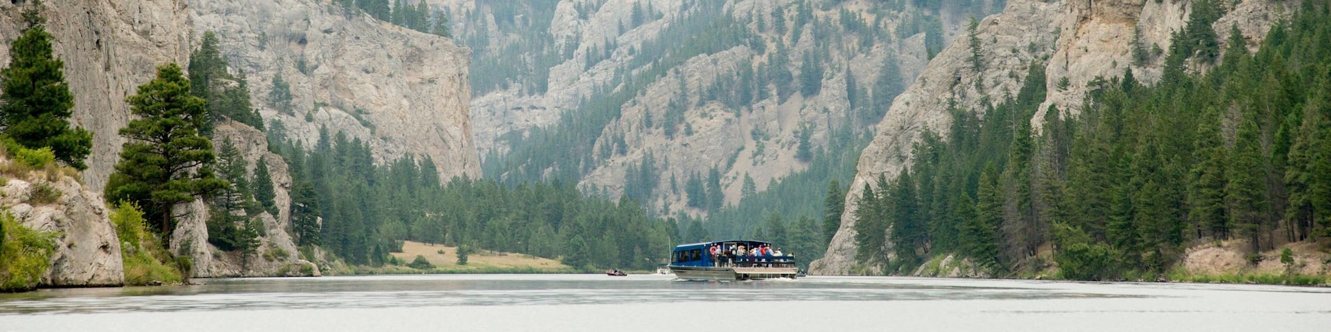 Gates of the Mountains Marina which includes a ferry, a lake or waterhole and mountains