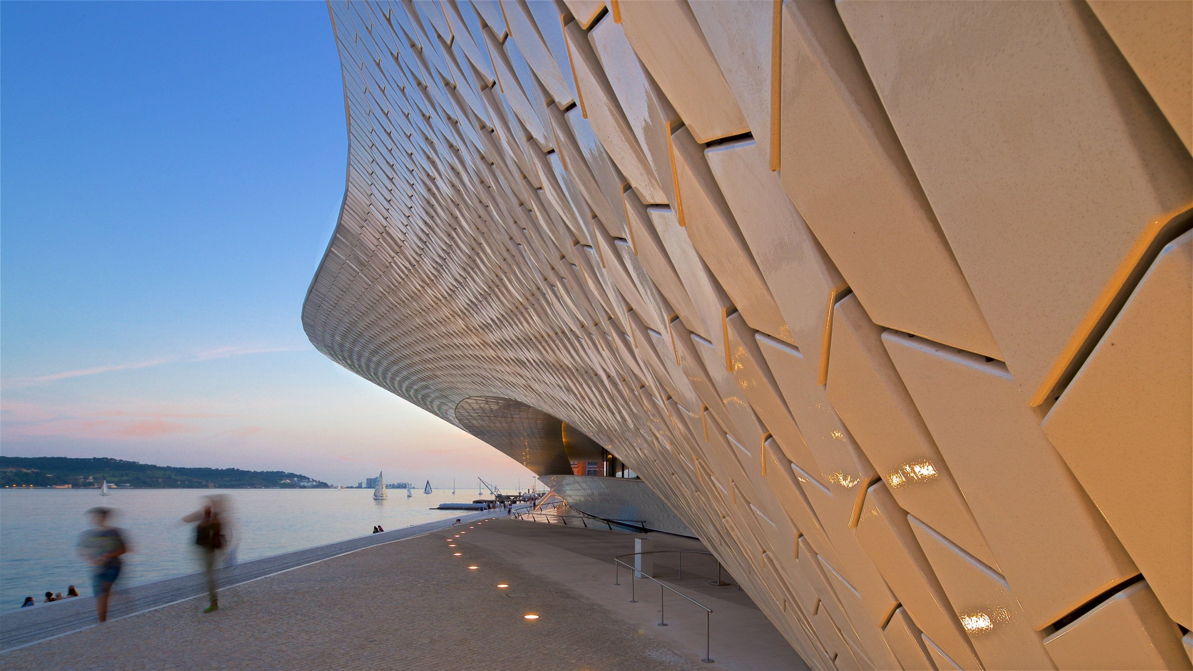 Lisbon District featuring modern architecture, a bay or harbor and a sunset