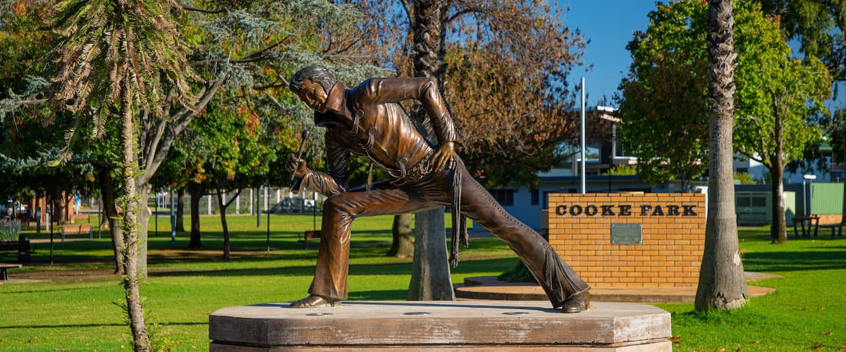Cooke Park featuring a garden and a statue or sculpture