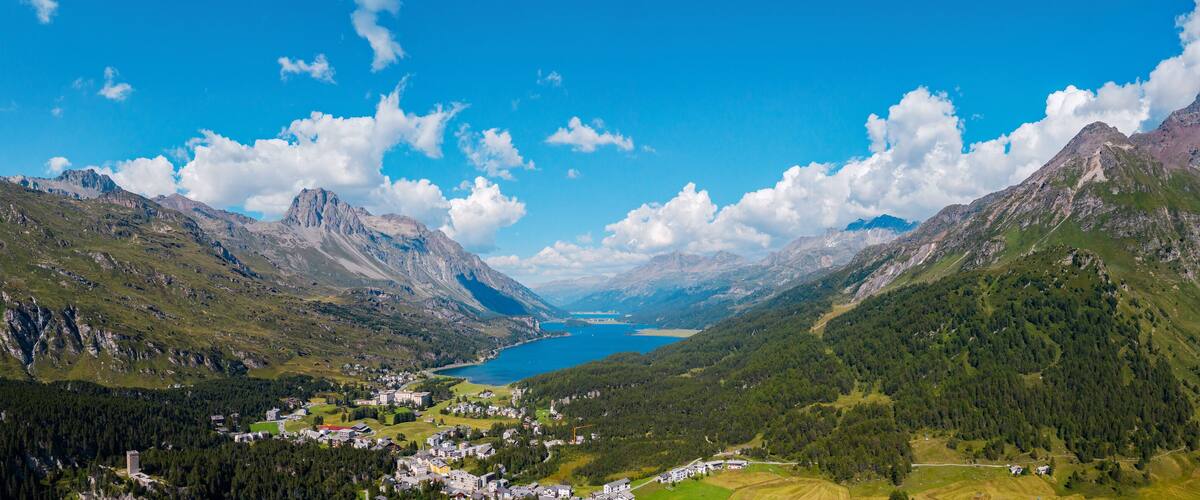 A mountainous landscape with a lake and a village.