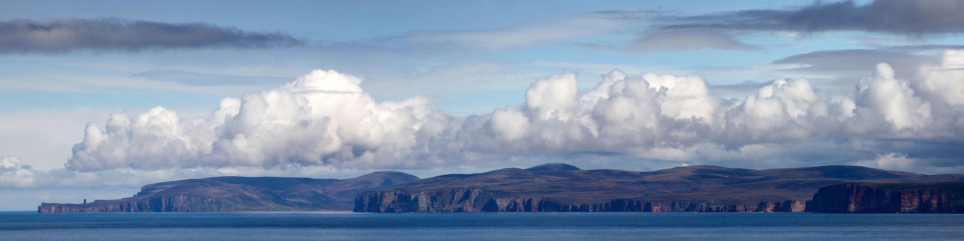 Panoramic view over the Pentland Firth in Caithness, Scotland to the Orkney island of Hoy with the Old Man of Hoy in the background