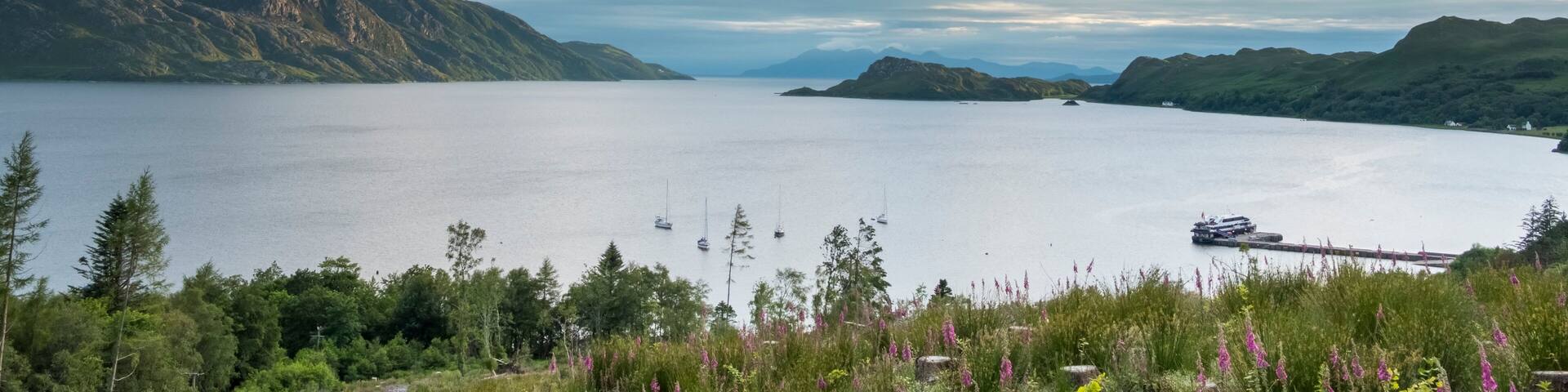 Big skies hang over Loch Nevis where a small ship is docked near Inverie, Scotland; Inverie, Scotland