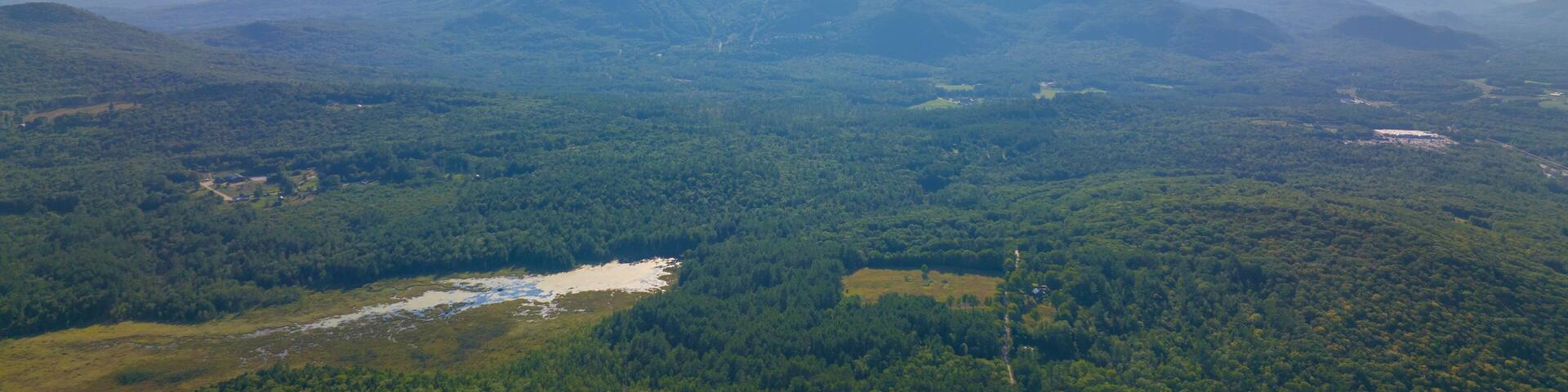 Tenney Mountain aerial view in summer with Groton Wind Power field at the background in Plymouth, New Hampshire NH, USA.
