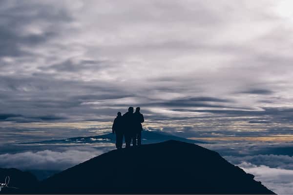 Trekking to 4565m high summit of Mount Meru in Tanzania. A hike through the beautiful national park of Arusha and meeting the african wildlife. One makes this trip unforgettable, a constant view on the wonderful Kilimanjaro. This early morning photo is taking just below the top of Mount Meru between two layers of clouds and only the peak of Kilimanjora on the Horizon. #nationalpark #africa #summit #meru #wilderness #travel #hiking #mountains