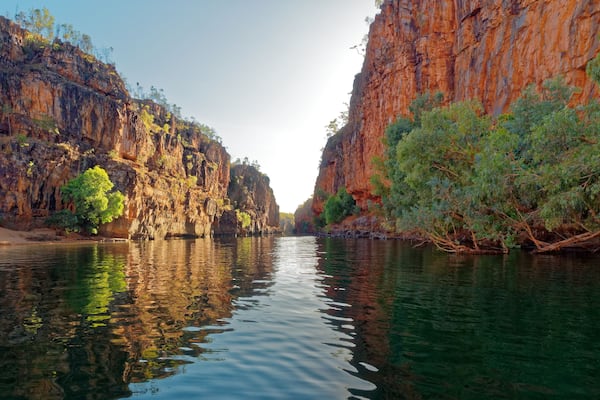 A river canyon with steep cliffs and sparse vegetation.