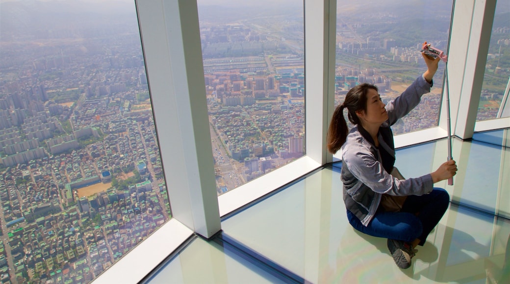 Lotte World Tower which includes a city, a sunset and interior views