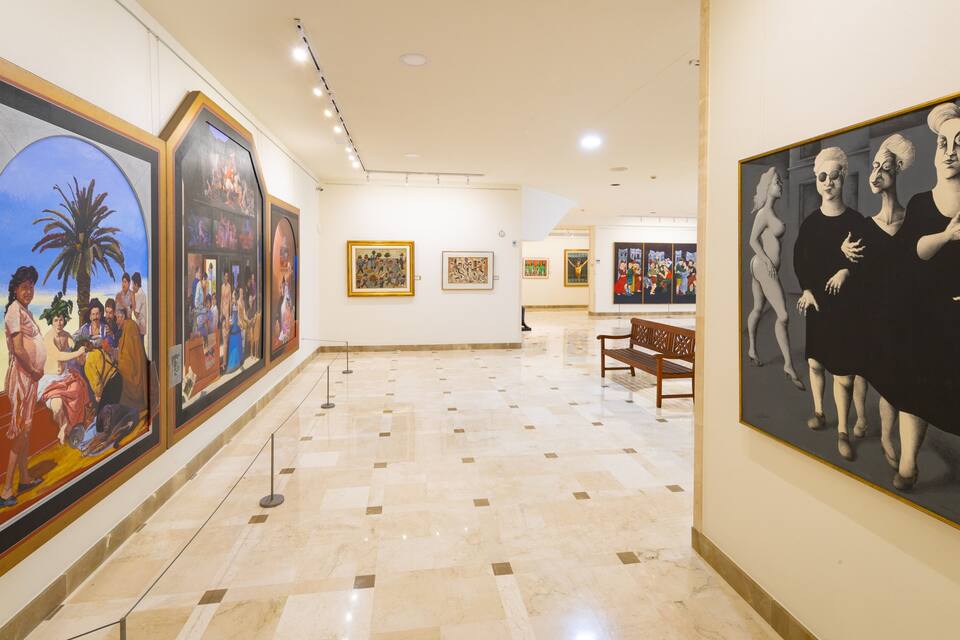 An art gallery with various paintings on display.