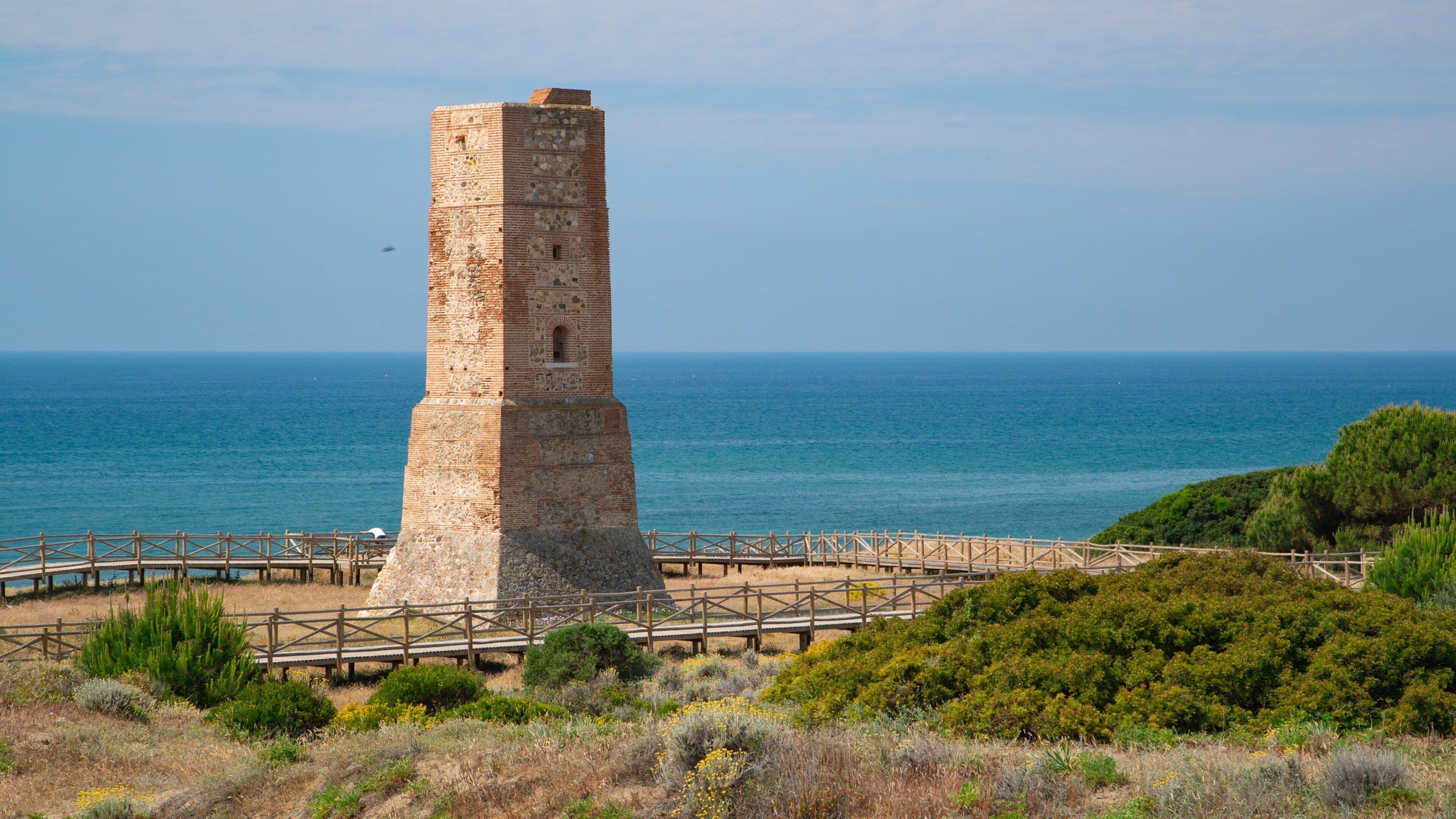 Cabopino Beach which includes general coastal views and heritage architecture