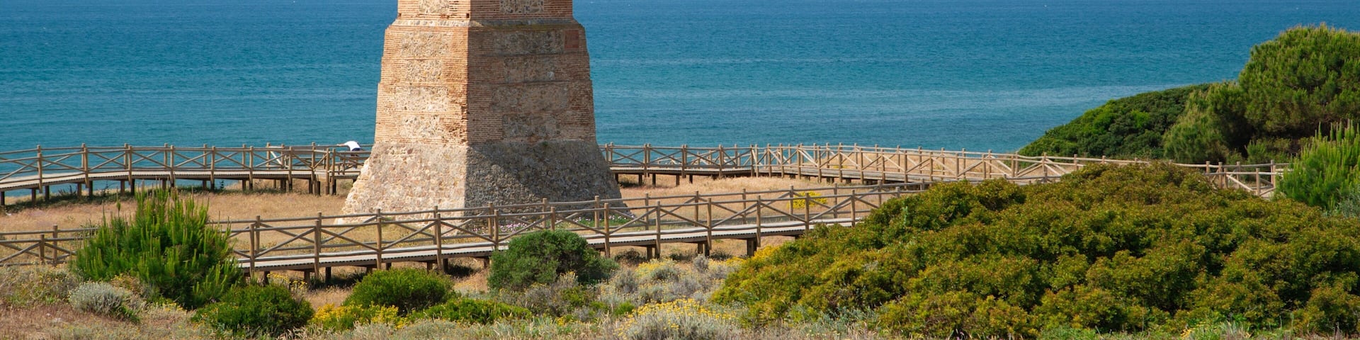 Cabopino Beach which includes general coastal views and heritage architecture