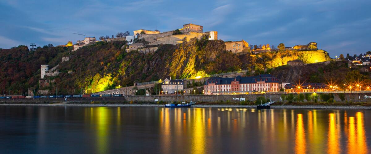 Ehrenbreitstein Fortress showing a small town or village, a river or creek and night scenes