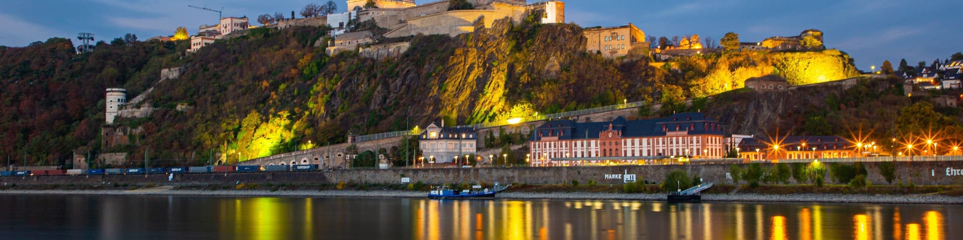 Ehrenbreitstein Fortress showing a small town or village, a river or creek and night scenes