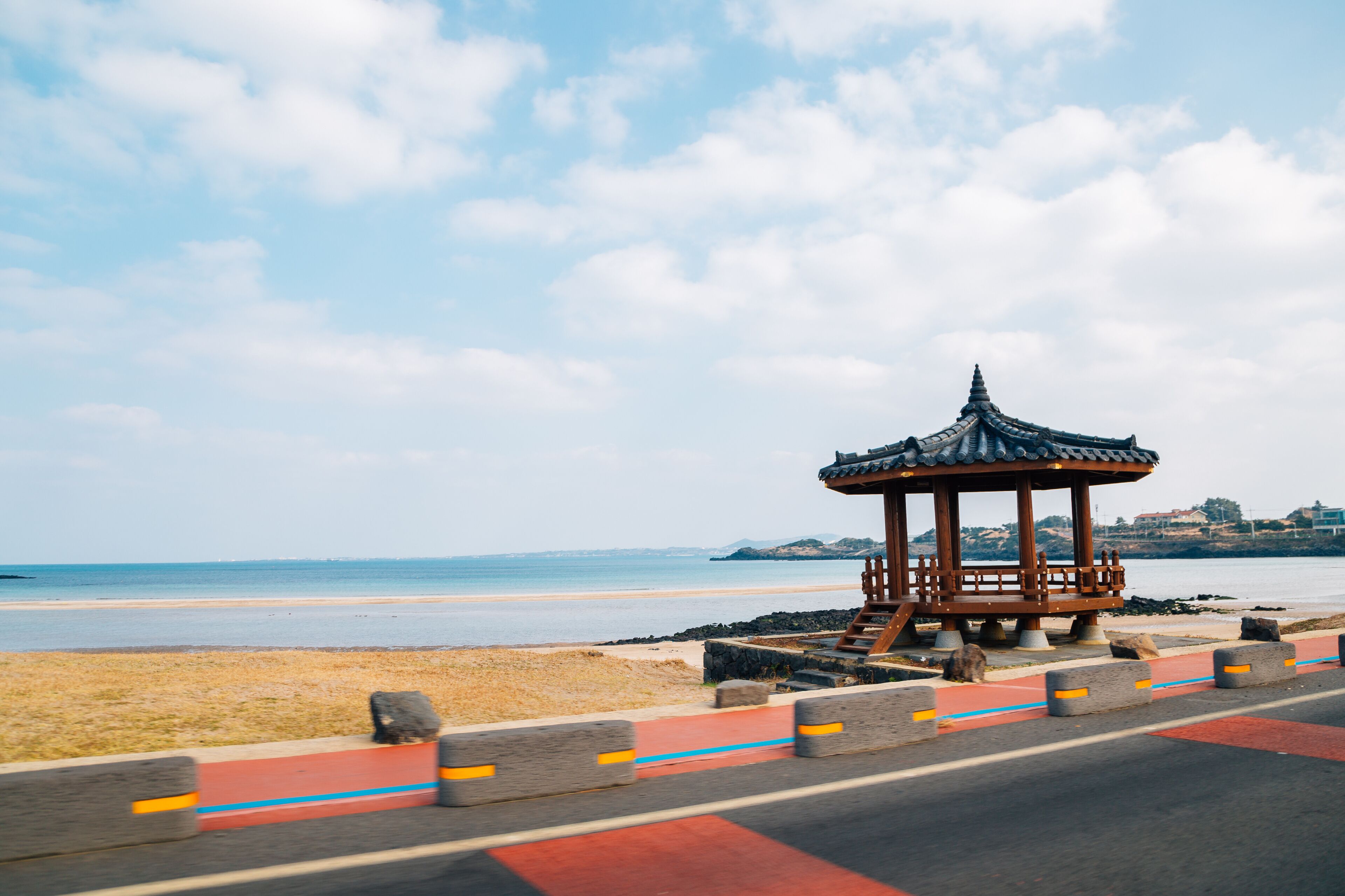 Seaside driving coastal road and Korean traditional pavilion in Jeju Island, Korea