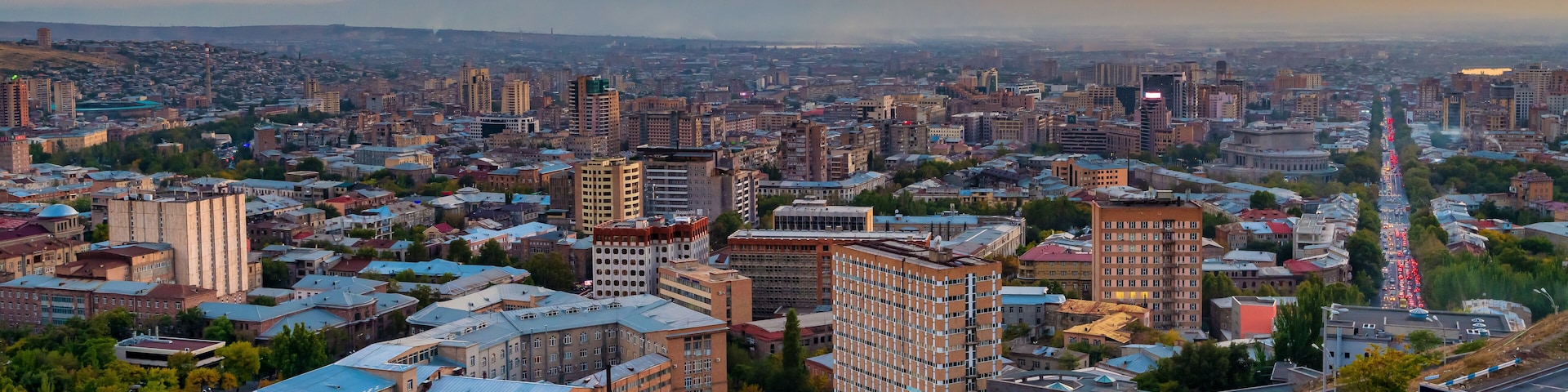 A cityscape with a prominent mountain in the background and a river running through the center.