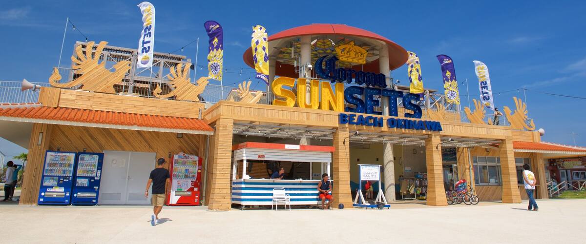 Okinawa which includes signage, a coastal town and cafe scenes