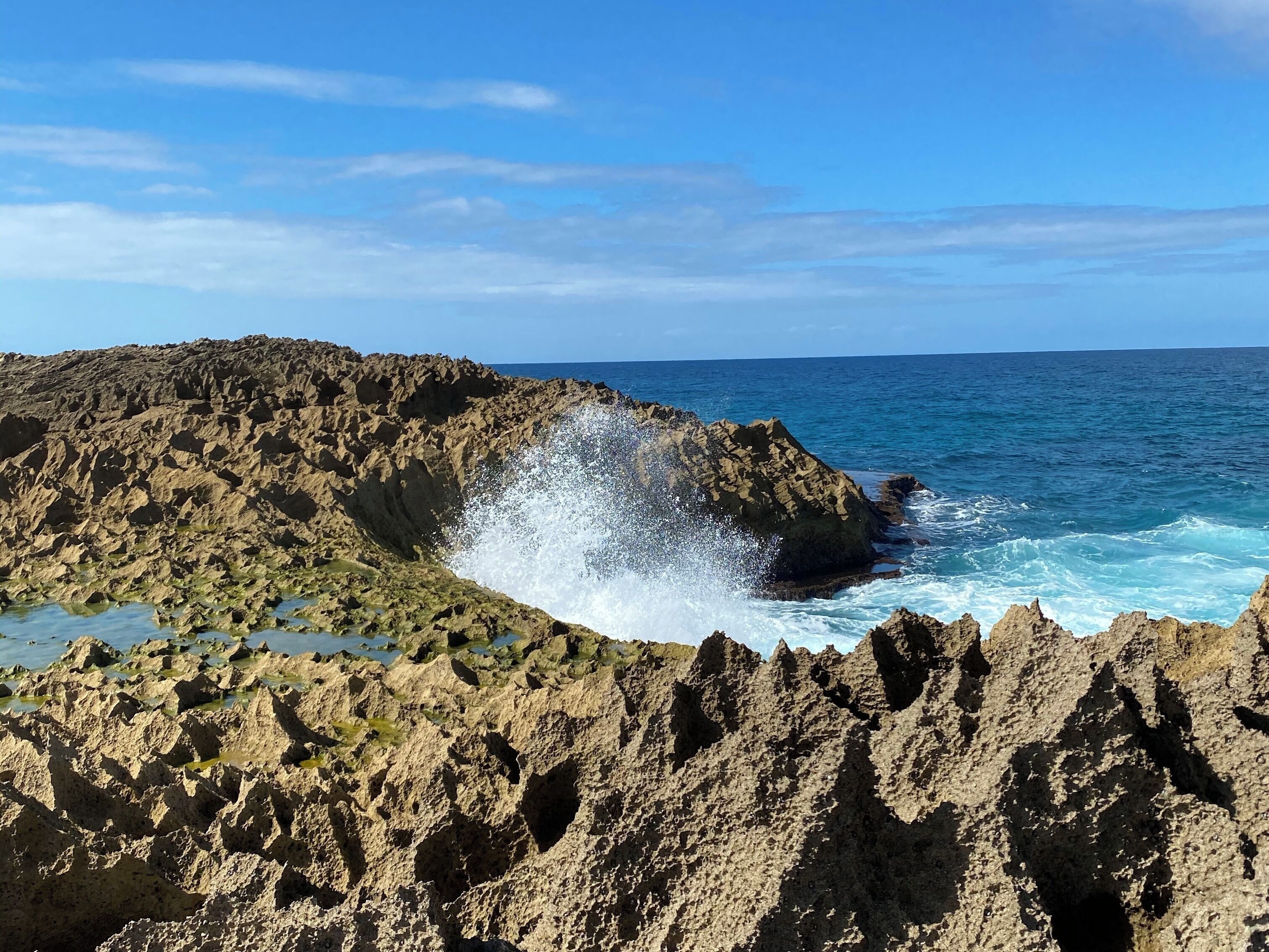 A rocky coastline with waves crashing against the rocks.