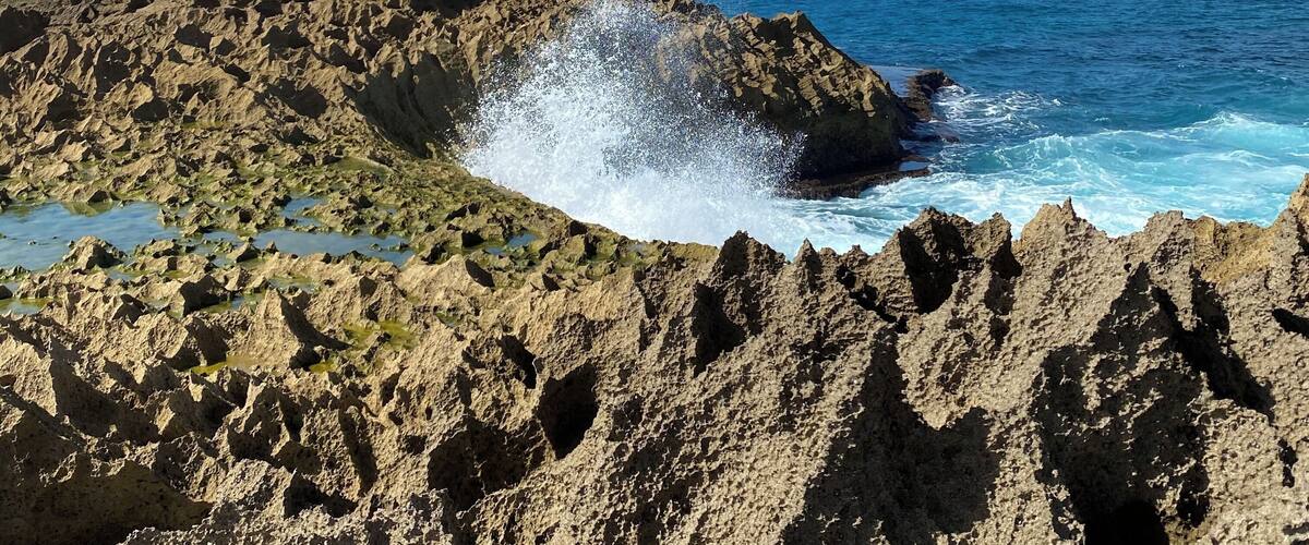 A rocky coastline with waves crashing against the rocks.
