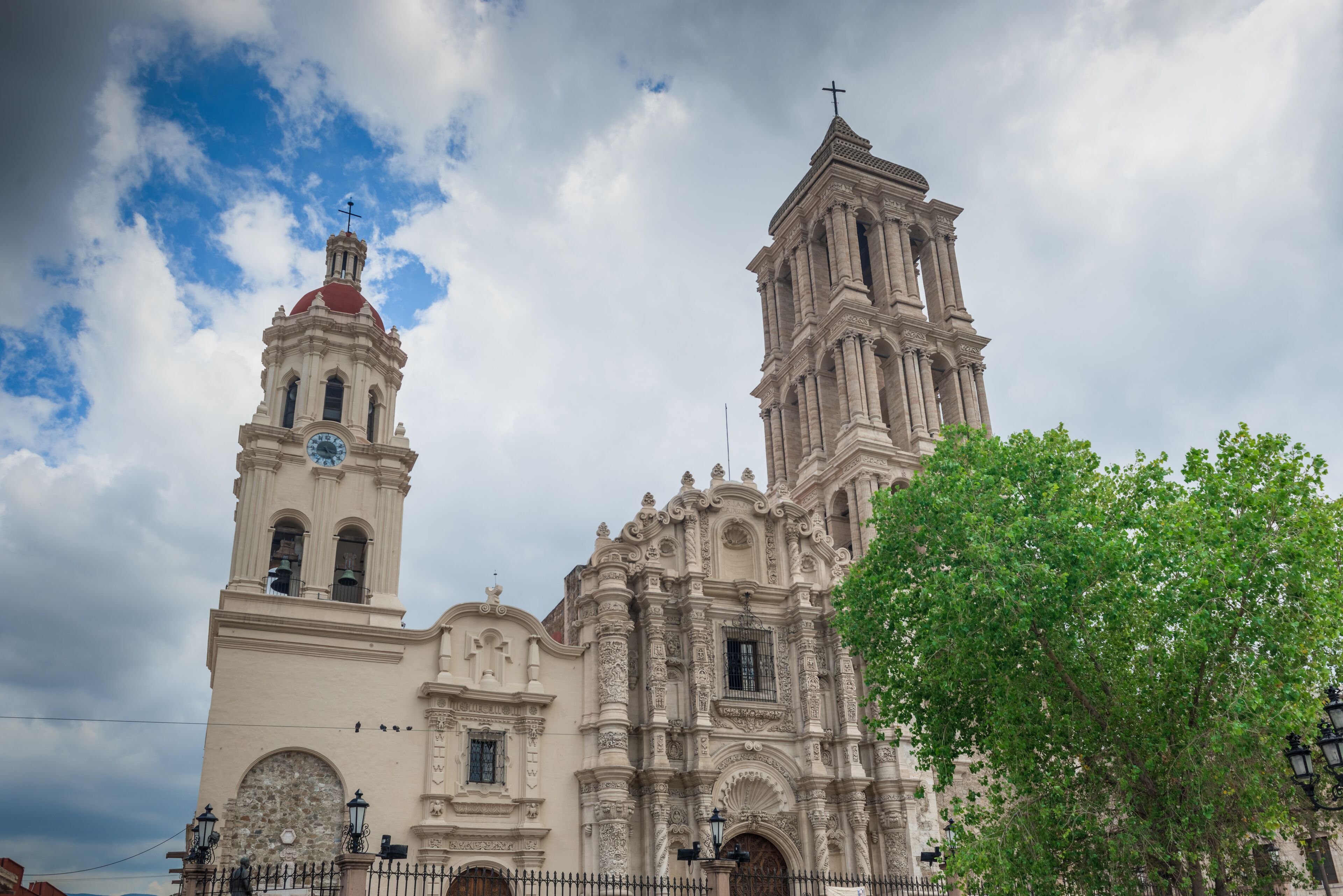 A historic church with a bell tower and a large dome.