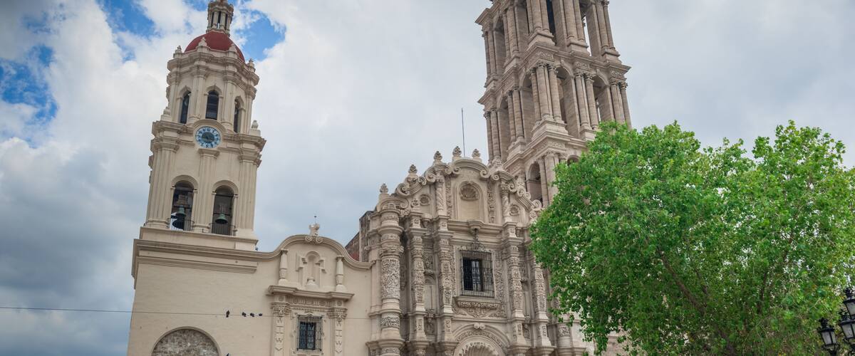A historic church with a bell tower and a large dome.