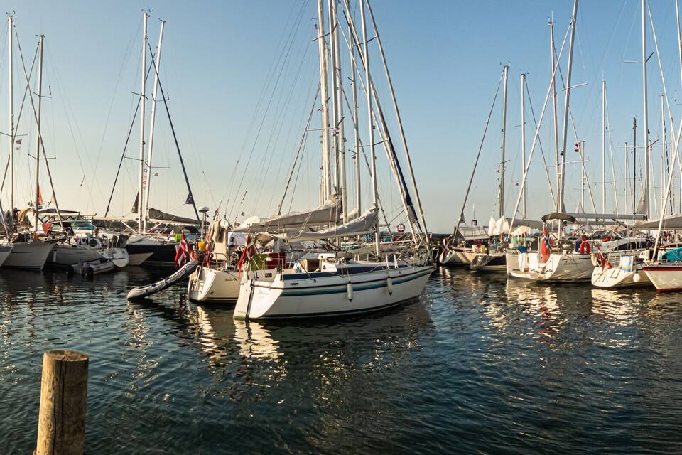 Una marina con numerosi cabinati ormeggiati a pontili in legno.