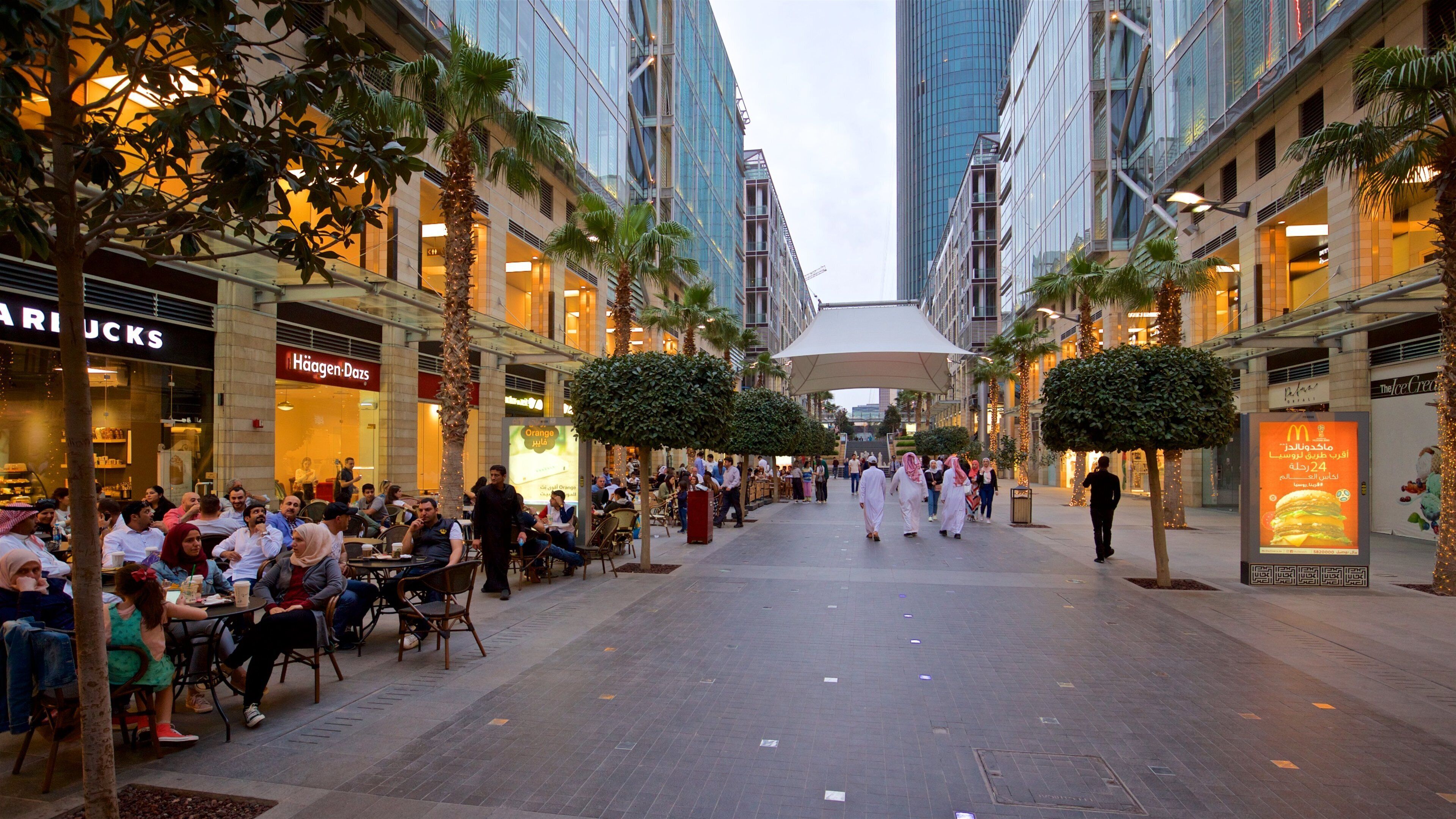 Al Abdali Mall featuring outdoor eating as well as a small group of people
