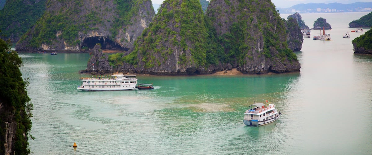 Halong Bay which includes a bay or harbour, boating and mountains