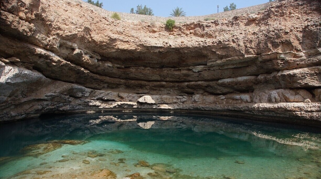 Bimmah Sinkhole is clearly marked on any decent map of Oman, clearly signposted off the highway & thereafter and you do not require a 4WD to get to it. That being said, every time I go there, I think I have missed the turn and take a dirt track that you should not take in a normal car, only to realise that if I had stayed on the tarmac, the turnoff was just a bit further up the road! It takes about an hour from Muscat.
There are pan toilets here which double as changing areas. There are a few picnic spots as well.
To get to the water, you have to go down a lot of steps! The water is mildly salty and very clear. The shallows have those tiny fish that eat the dead skin off your feet and legs (free foot spa) and the deeper area is deep enough for jumping off the rocks into the Sinkhole - which plenty of people do. There are a variety of heights to jump from!
This is one of the first places I visited in Oman many moons ago and it is still a favourite. The surrounding scenery does not disappoint either as it is perched between the mountains and the sea.