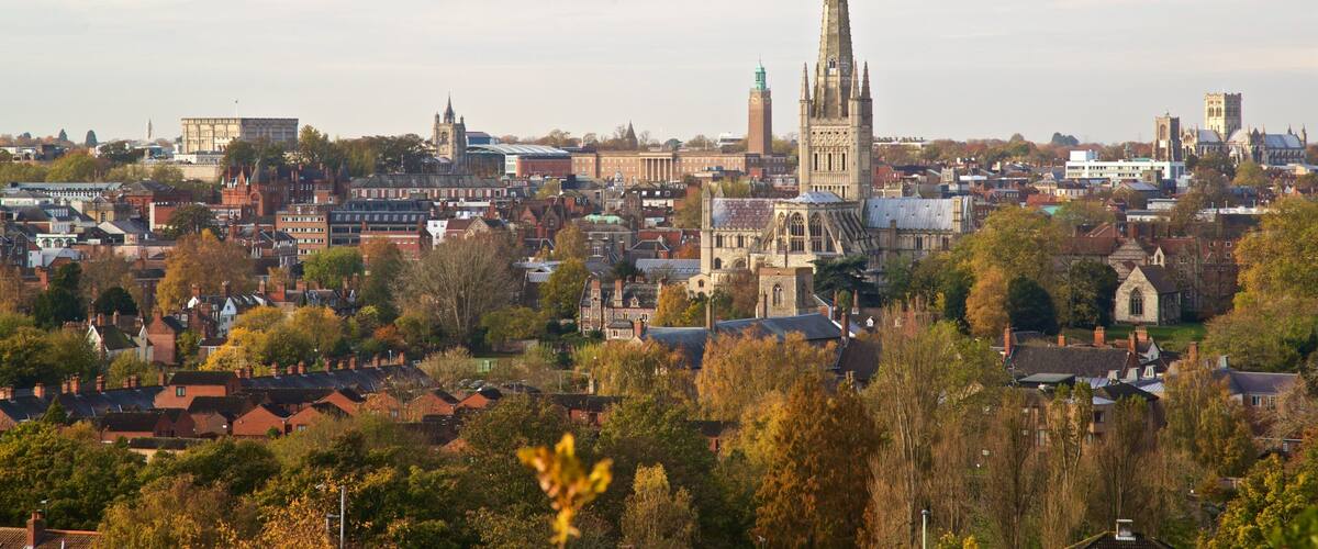 A cityscape with a prominent cathedral spire, historic buildings, and residential areas.