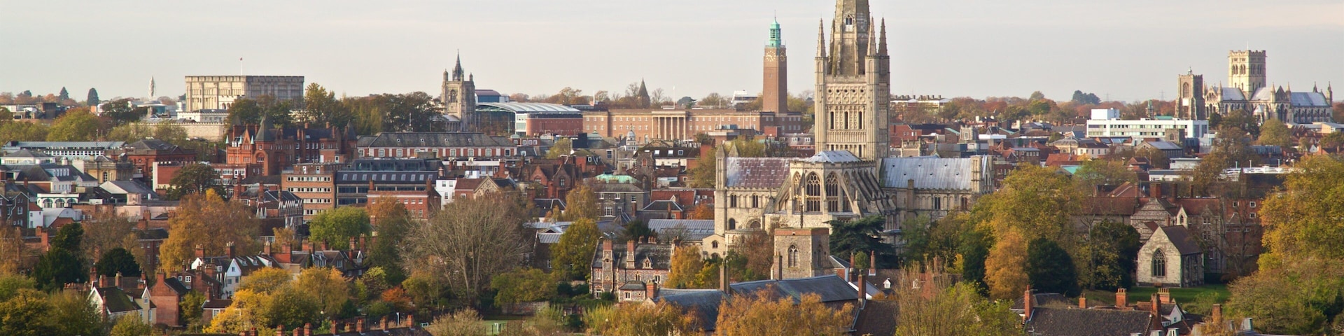 A cityscape with a prominent cathedral spire, historic buildings, and residential areas.
