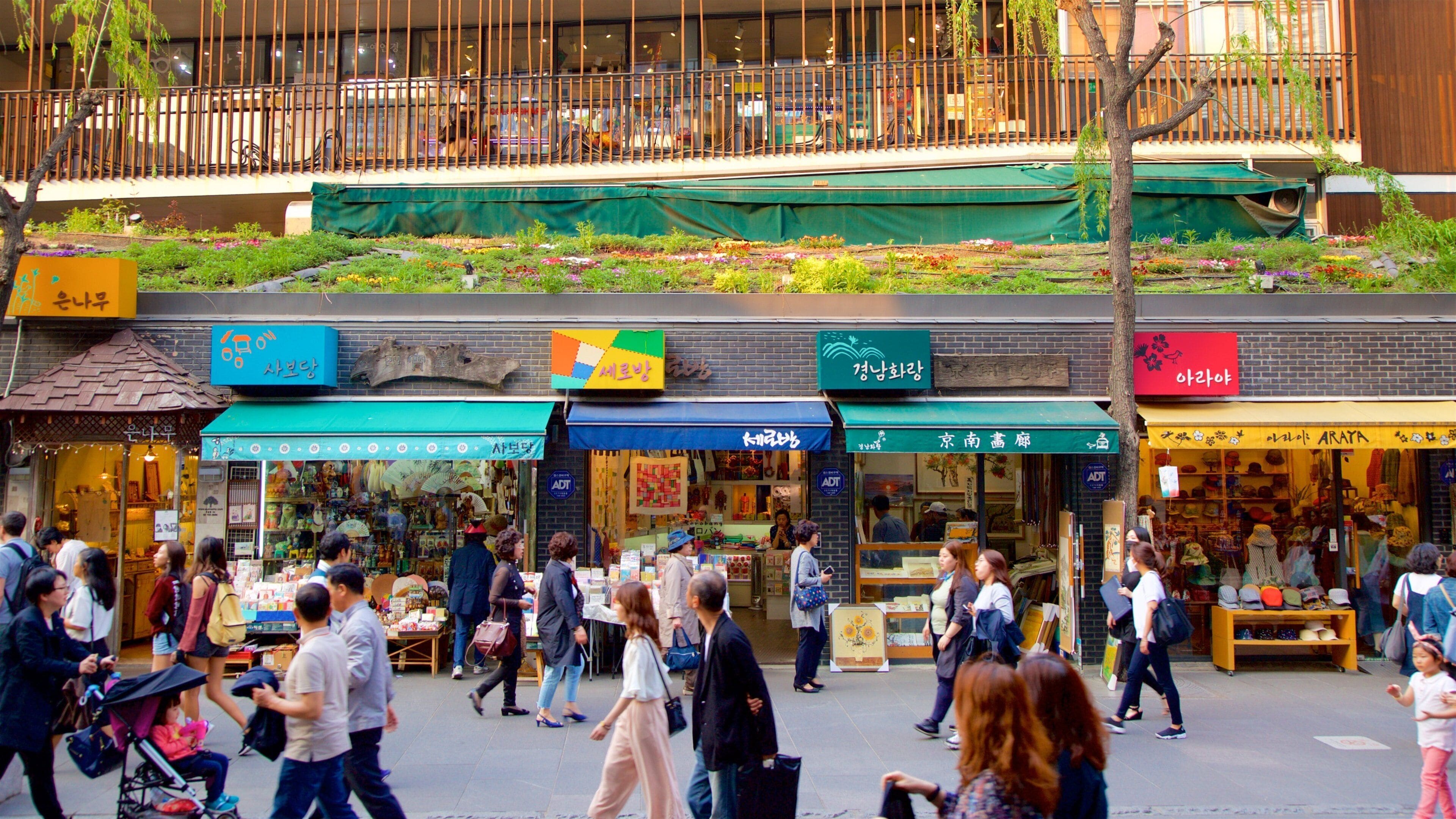 A bustling street market with various shops and pedestrians.