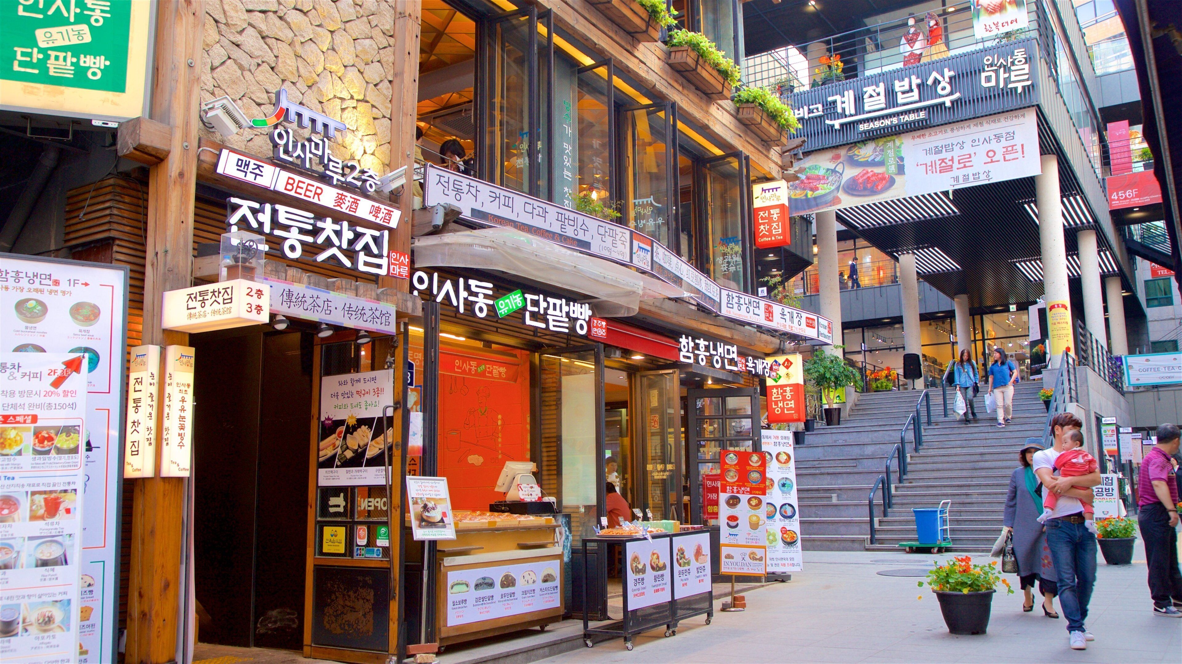 Insadong showing shopping and signage as well as a small group of people