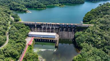 aerial landscape view of area around Bayano Dam and River "Rio Chepo" with bridge and Hydroelectric Power Plant surrounded by Rainforest, located in Vacamonte at Bayano Lake, Panama