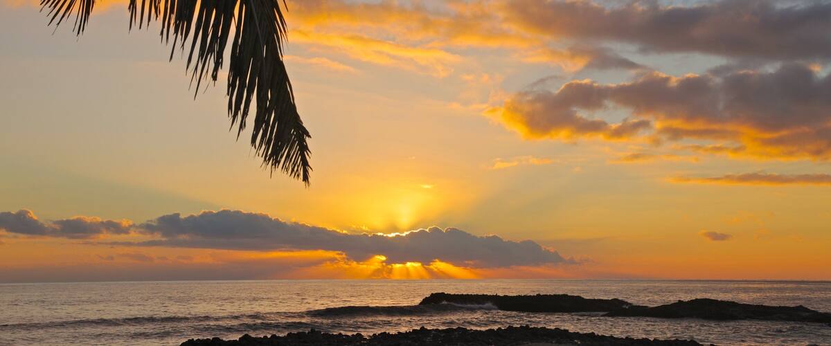 Kuata Island showing a sunset, landscape views and a beach