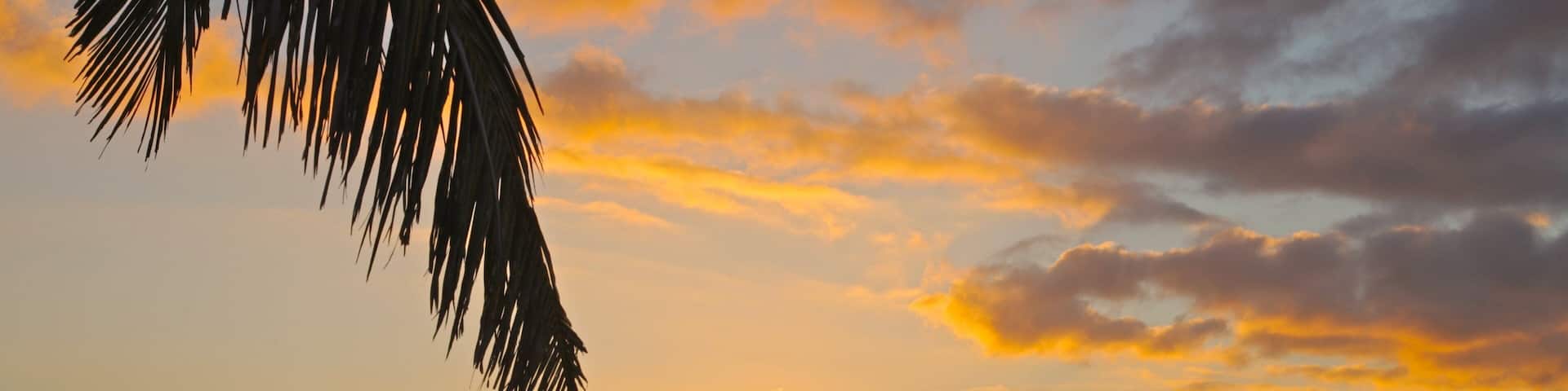Kuata Island showing a sunset, landscape views and a beach