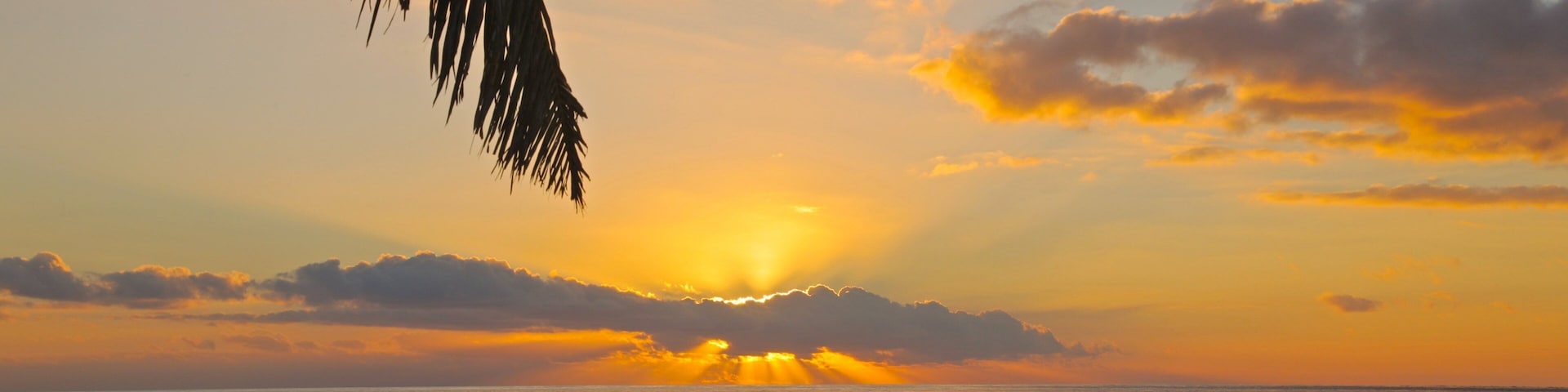 Kuata Island showing a sunset, landscape views and a beach