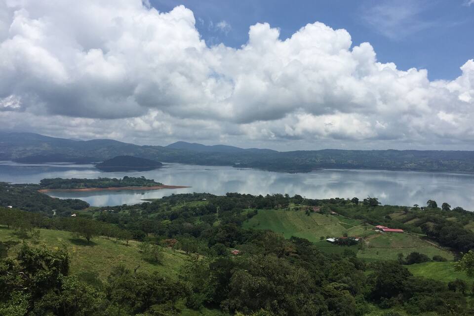 A lake surrounded by hills and trees.