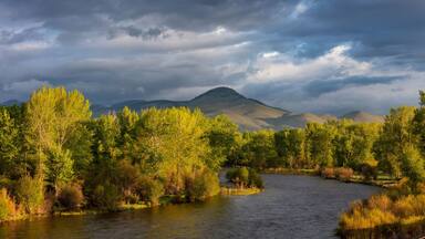 Dramatic stormy sunrise light strikes the Big Hole River near Melrose, Montana, USA