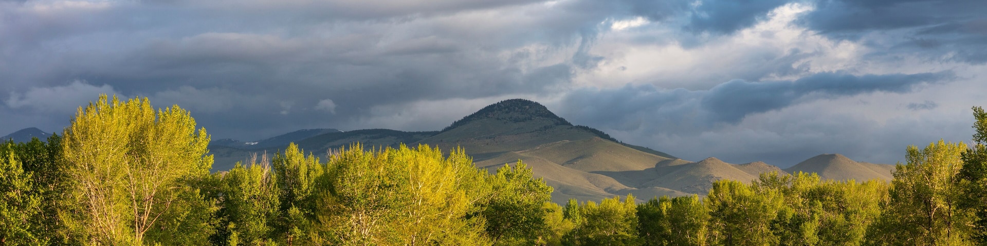 Dramatic stormy sunrise light strikes the Big Hole River near Melrose, Montana, USA