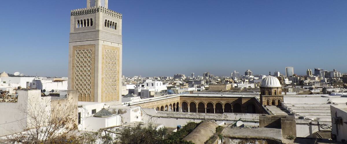 View of the Al-Zaytuna Mosque and the skyline of Tunis. The mosque is a Landmark of Tunis. In the Background the modern buildings of the new City or "ville nouvelle". Tunisia, North africa.