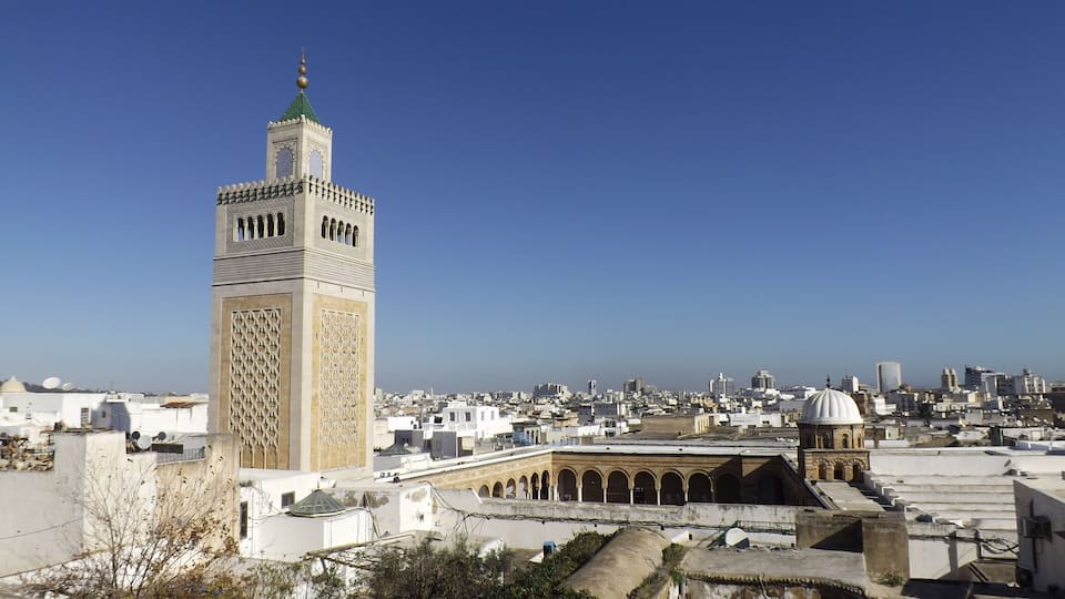 View of the Al-Zaytuna Mosque and the skyline of Tunis. The mosque is a Landmark of Tunis. In the Background the modern buildings of the new City or "ville nouvelle". Tunisia, North africa.