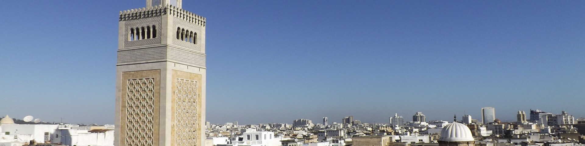 View of the Al-Zaytuna Mosque and the skyline of Tunis. The mosque is a Landmark of Tunis. In the Background the modern buildings of the new City or "ville nouvelle". Tunisia, North africa.