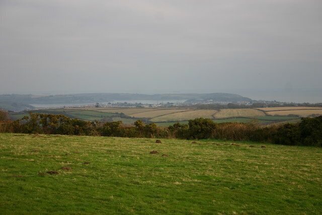 Falmouth, Carrick Roads, and Roseland Peninsula from near Trenoweth Lane View looking south east over fields towards Falmouth, the ria of Carrick Roads, the Roseland Peninsula, and then to the sea beyond.