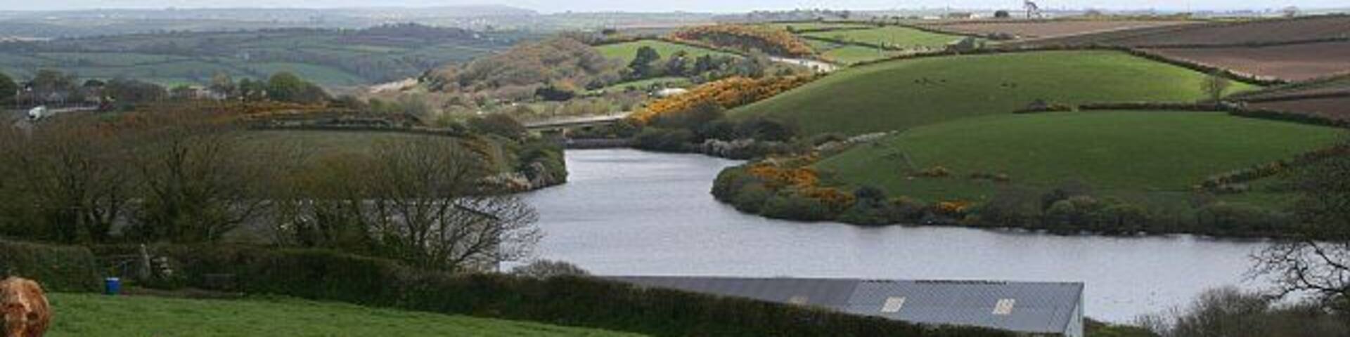 The View Over College Reservoir. This photograph is taken from a viewpoint on the road south of Antron as the road starts to drop down into the valley. It looks over and well beyond the grid square.