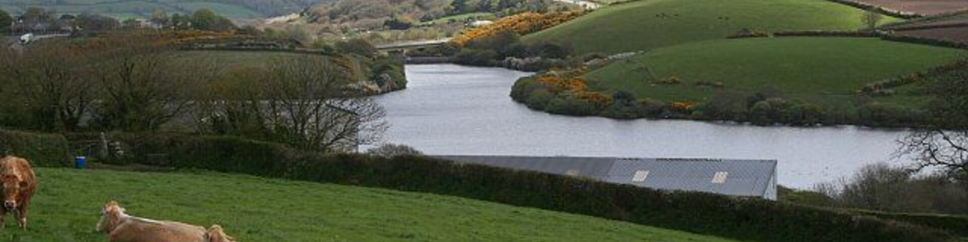 The View Over College Reservoir. This photograph is taken from a viewpoint on the road south of Antron as the road starts to drop down into the valley. It looks over and well beyond the grid square.
