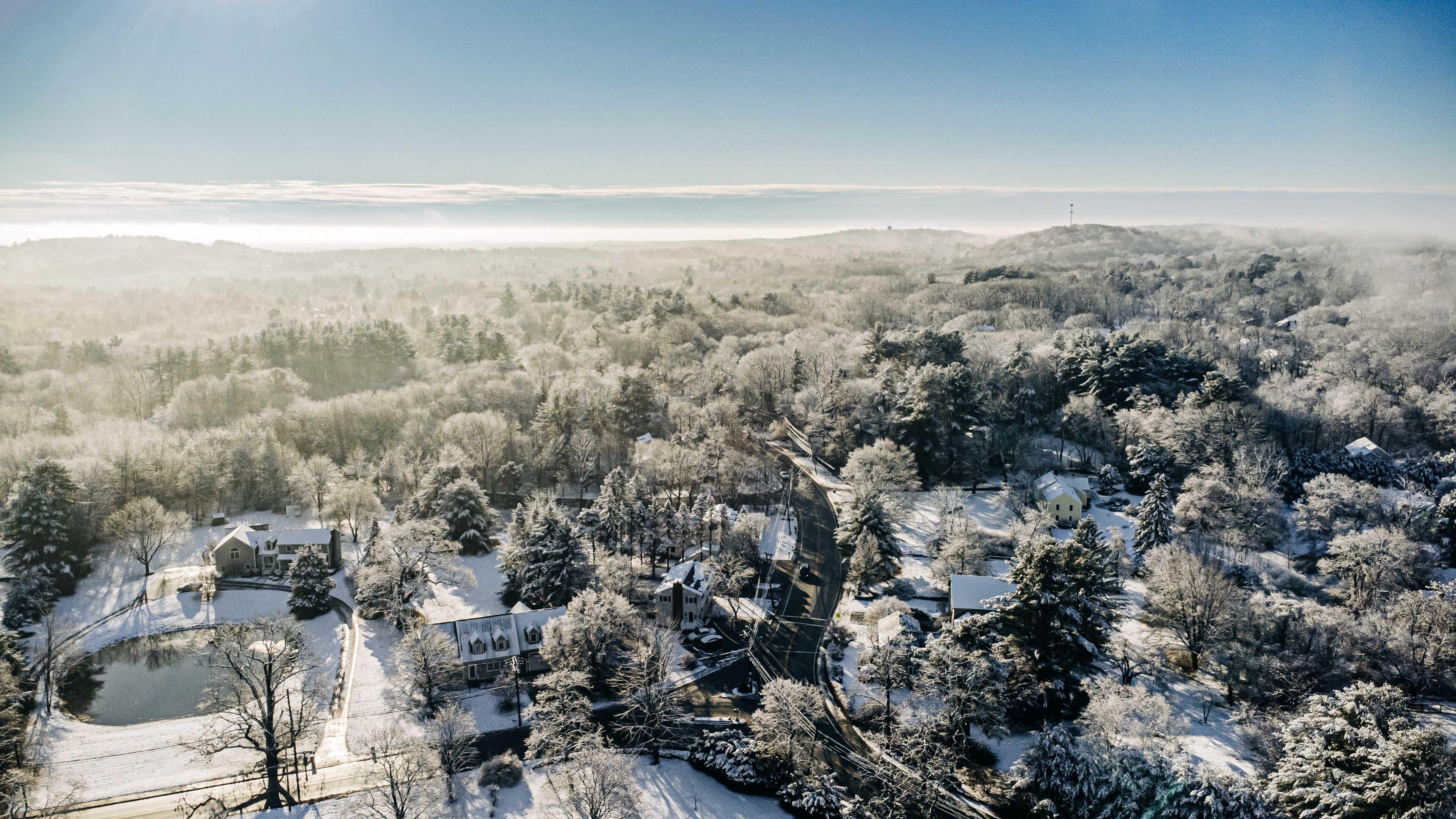 A snow-covered landscape with houses and trees.