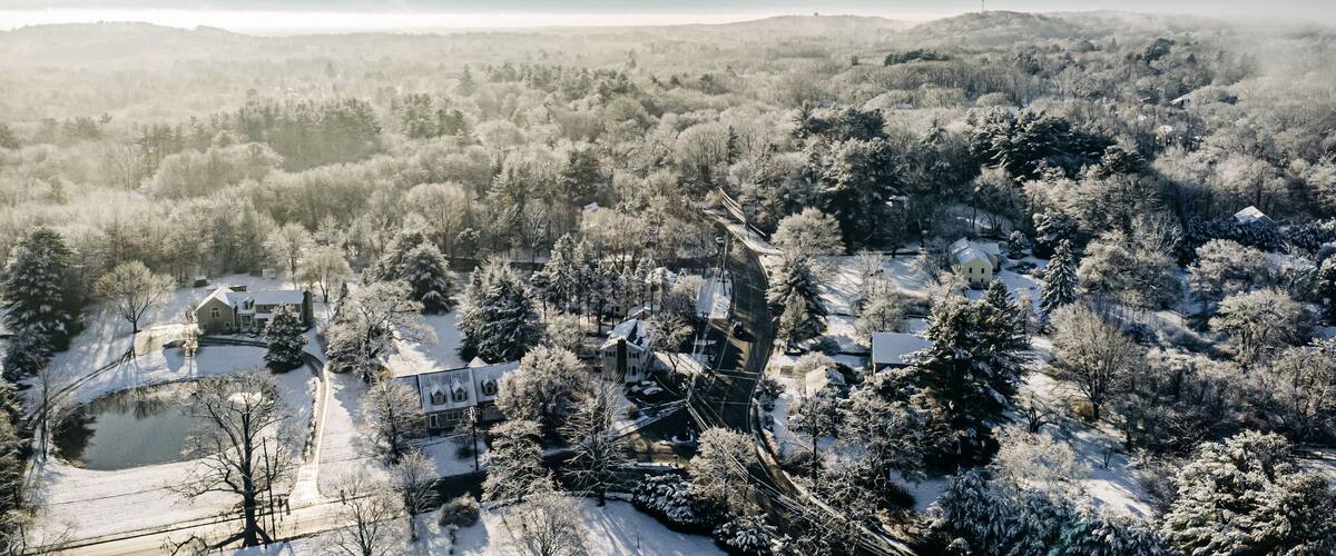 A snow-covered landscape with houses and trees.