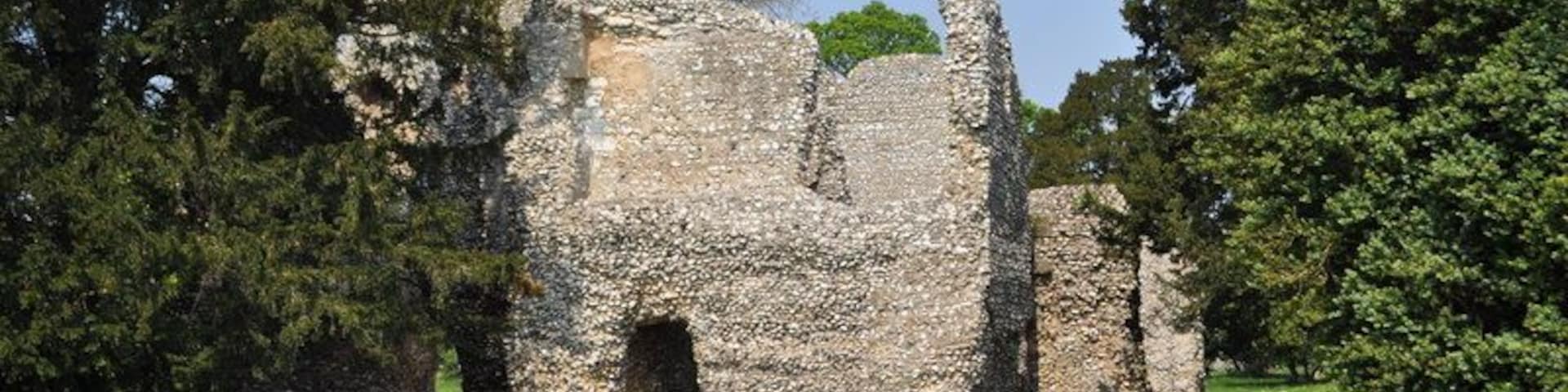 Weeting Castle, near to Weeting, Norfolk, Great Britain. Weeting Castle is a 12th-century ruin with a three-story-high tower in Weeting, near Brandon, Norfolk. Despite the name, it is not a castle but actually a fortified manor house. It has a large open hall and an attached two-storey chamber block. There's a domed brick ice-house on the northwest corner of the moat and a small car park next to the church. The moat was added in the 14th century. The place is thought to have been abandoned in 1390. The manor was built on a 10th C settlement. It is now owned by English Heritage. Entry is free and the location is open all year for visitors.