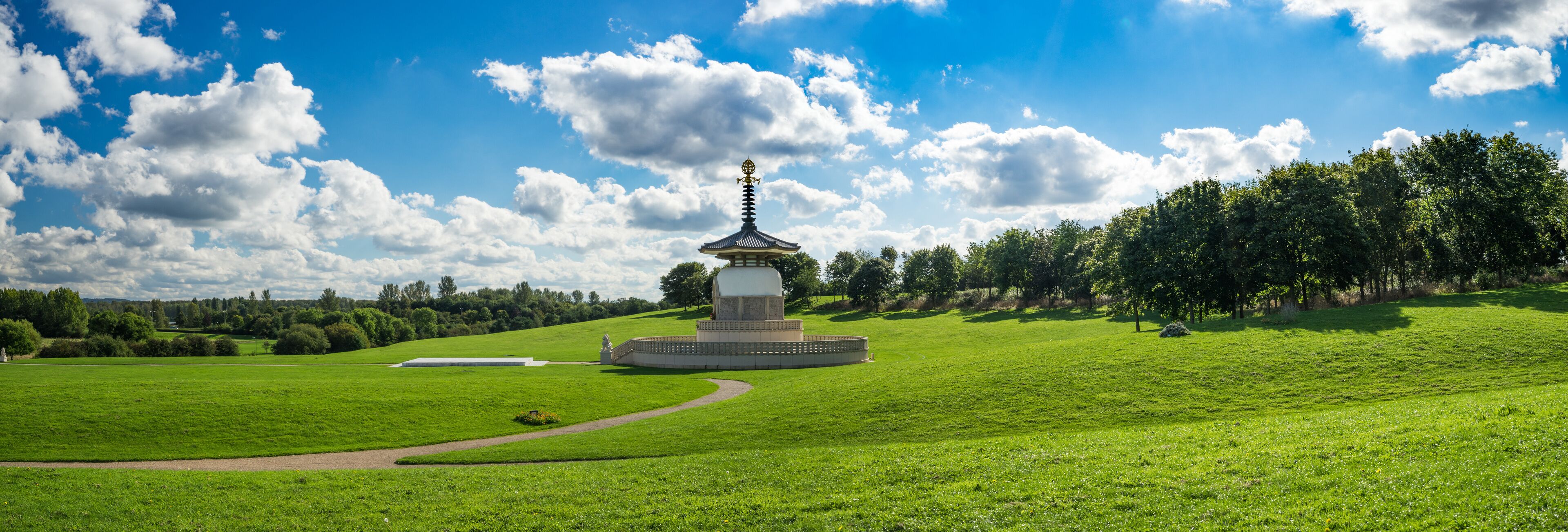 Panorama of Lakeside Willen Park with Peace Pagoda Temple at sunny summer day in Milton Keynes, England