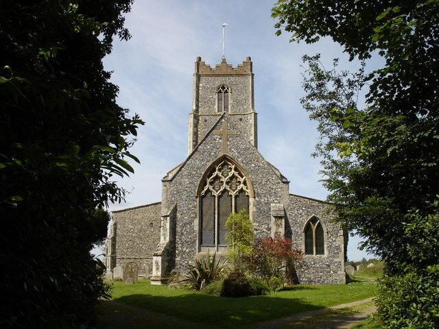 A stone church with a tall tower and arched windows.
